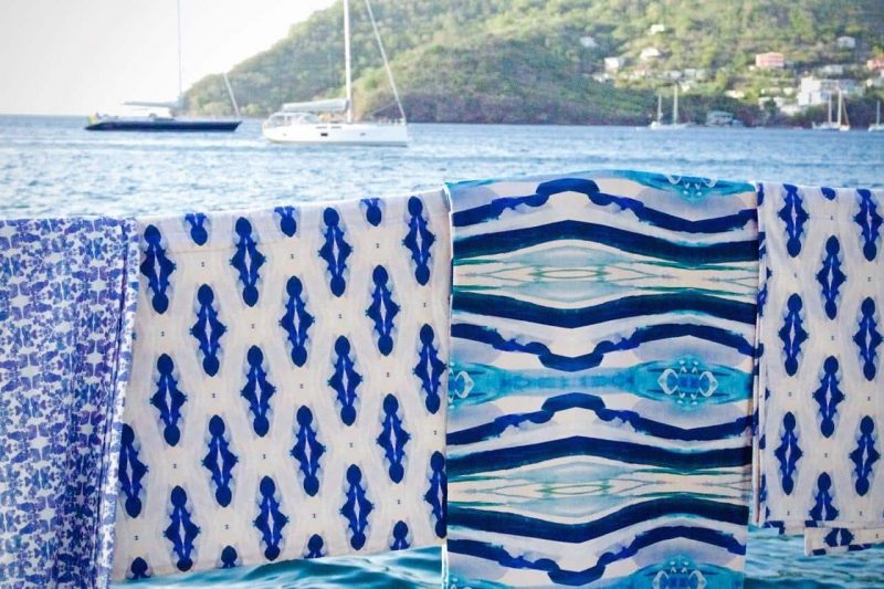 Luxury patterned organic quilts hanging on a sailboat railing