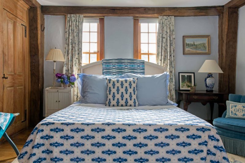 Light blue bedroom with organic diamond pattern quilt and pillow on the bed