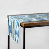 Luxury organic abstract watercolor stripe tabble runner hanging off a table