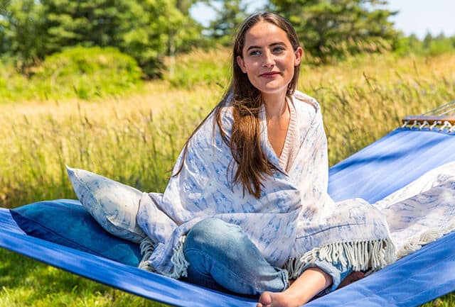 A woman wrapped in a plush throw