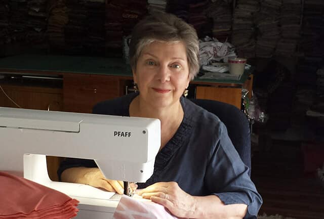 Sewer Catherine Gentile at a Pfaff sewing machine