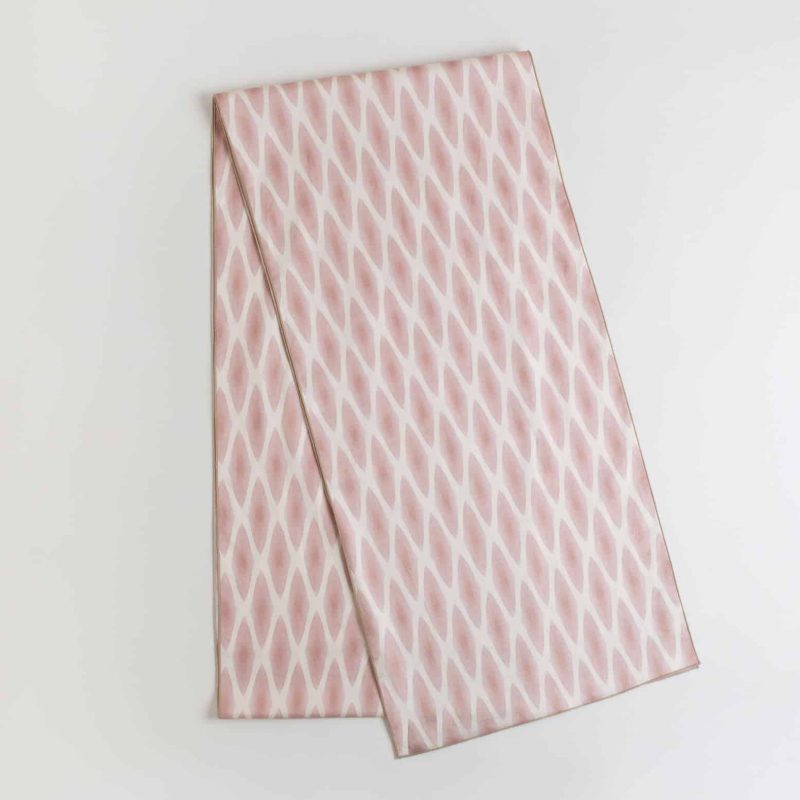 Pink and white patterned table runner